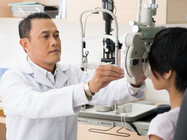 Male doctor performing an eye exam.