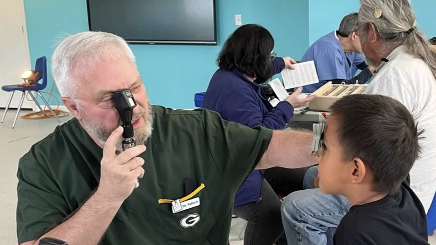 Dr. Moen provides vision screening to a child