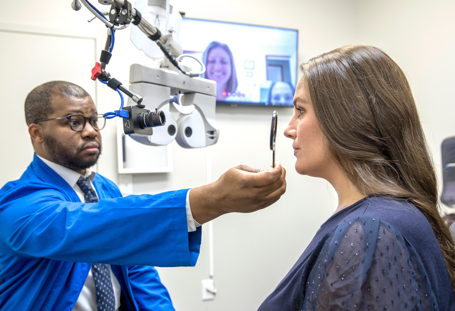 Woman smiling reviewing an image with a patient